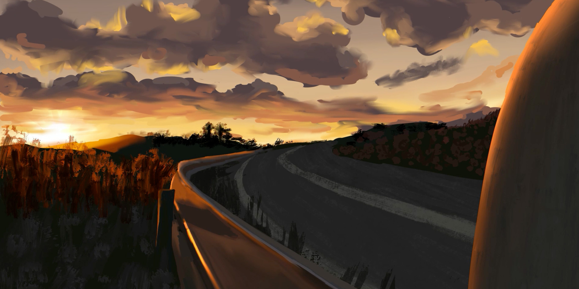 Sunset view of a cloudy sky above a winding road.