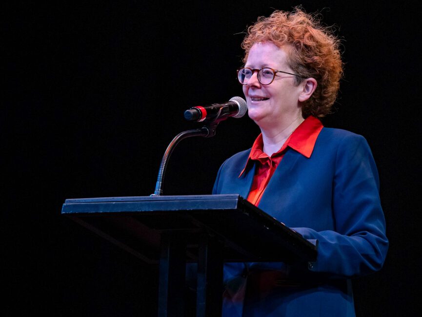 A person speaks into a microphone.